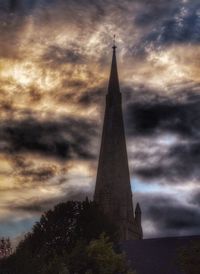 Low angle view of tower against cloudy sky