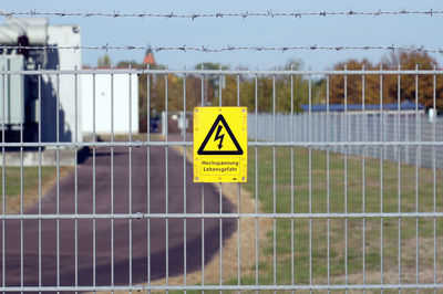 Information sign on fence