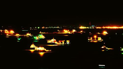 Boats in harbor at night