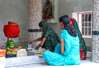 Women sitting on chair at home