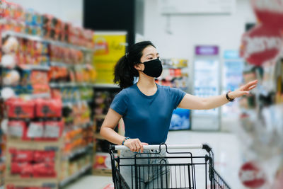 Young woman standing at store