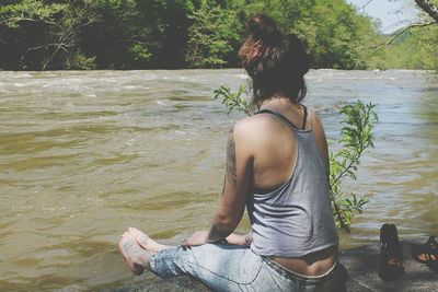 Woman sitting in swimming pool