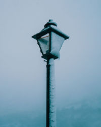 Low angle view of street light against blue sky