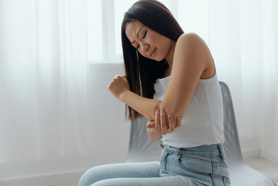 Young woman having elbow ache