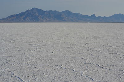 Scenic view of landscape against mountains at bonneville salt flats