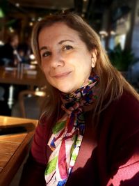 Portrait of smiling woman sitting at restaurant