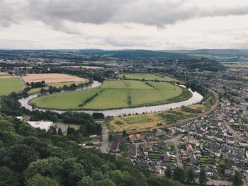 Aerial view of green landscape against sky