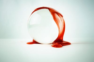 Close-up of orange on table against white background