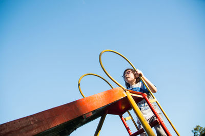 Child sliding in playground