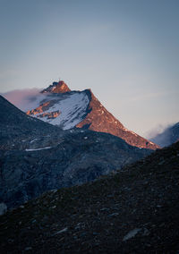 Low angle view of snowcapped mountain against sky