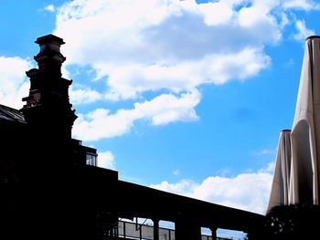 Low angle view of silhouette sculpture against sky