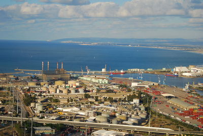 View of cityscape against cloudy sky