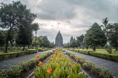 Panoramic view of formal garden against cloudy sky