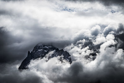Scenic view of mountain amidst clouds
