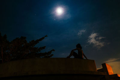 Low angle view of silhouette man against sky at night