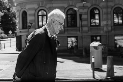 Man with umbrella on street in city