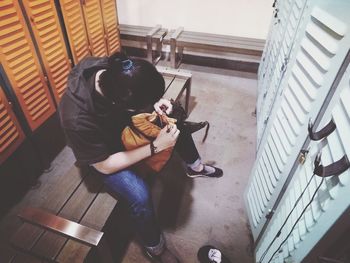 High angle view of man sitting on floor