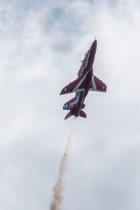 Low angle view of airplane flying against sky