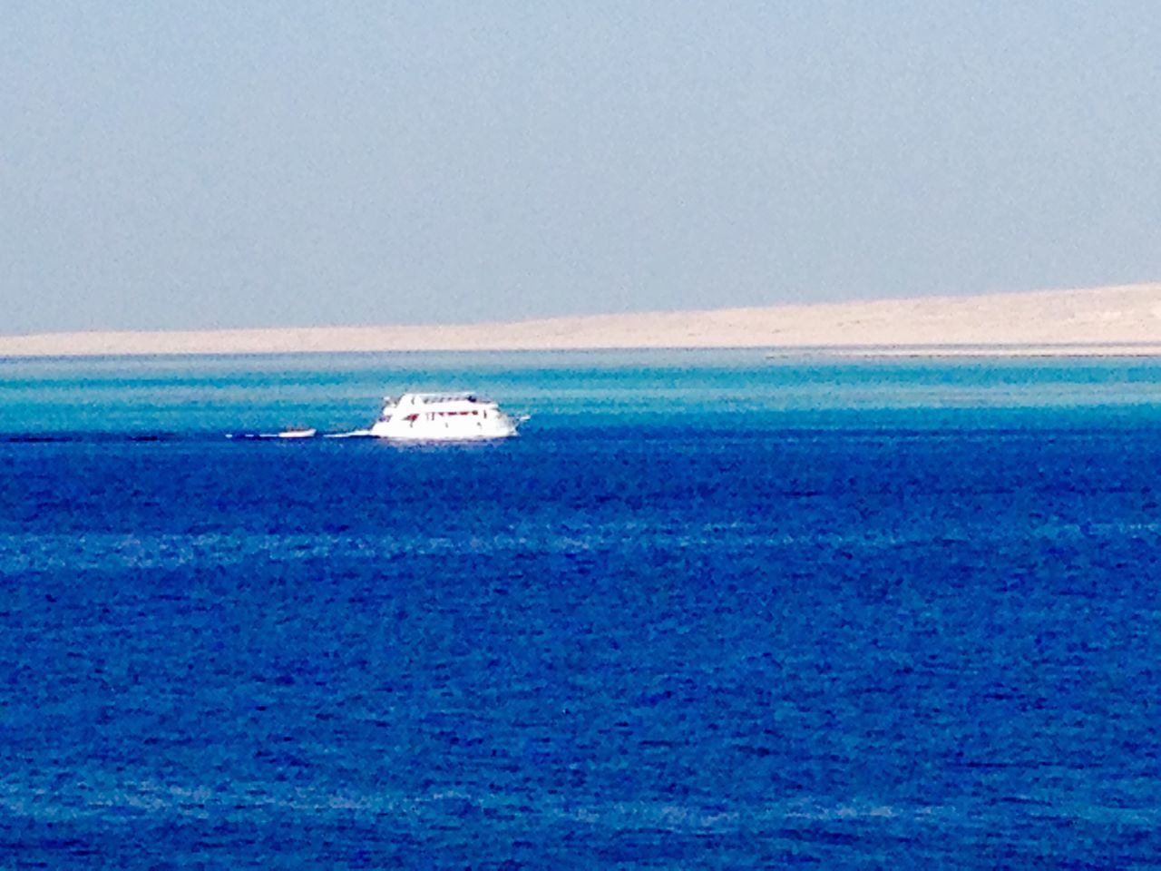 sea, water, nautical vessel, waterfront, transportation, boat, blue, horizon over water, mode of transport, clear sky, copy space, tranquil scene, tranquility, scenics, rippled, beauty in nature, seascape, sailing, nature, idyllic