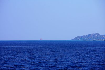 Scenic view of sea against clear blue sky