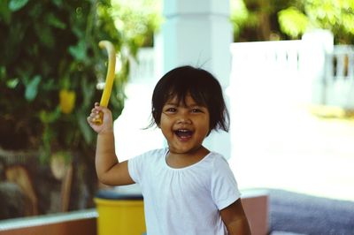 Portrait of smiling boy against trees