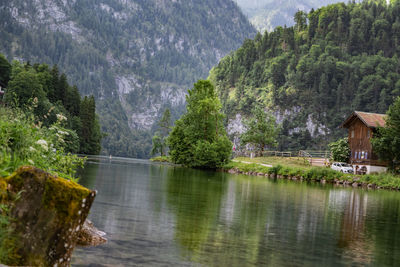 Scenic view of lake by trees against mountain