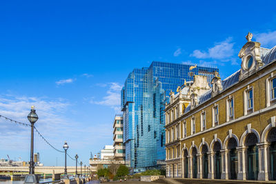 Low angle view of buildings against blue sky