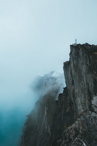 Rock formations by sea against sky