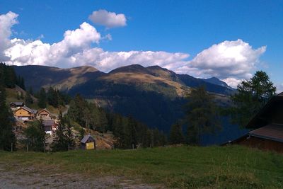 Scenic view of mountains against cloudy sky