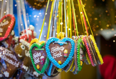 Close-up of heart shape cookies hanging on display at market stall
