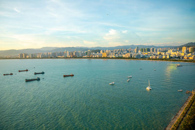 High angle view of harbor in city against sky