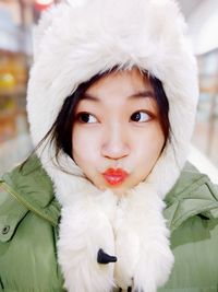 Close-up of woman wearing fur coat while at home