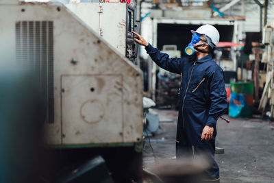 Full length of man working at bus