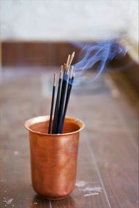 Close-up of incense sticks on table