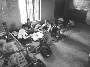 High angle view of people sitting on floor