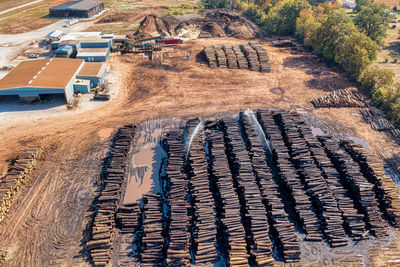 Aerial view of a sawmill log stacks yard with sprinklers, trucks and logging equipment. in tennessee