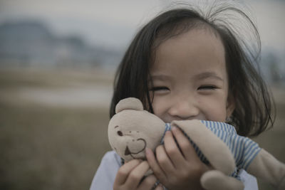 Close-up portrait of cute girl holding teddy bear