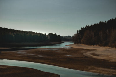 Scenic view of lake against sky during winter