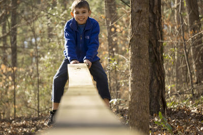 Portrait of a young man standing in forest