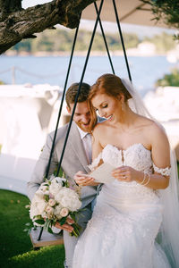 Portrait of young woman holding bouquet