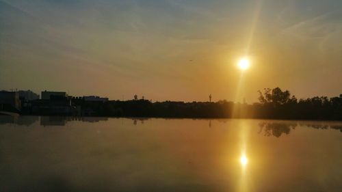 Scenic view of lake at sunset