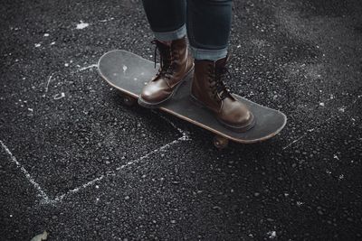 Low section of person standing on road