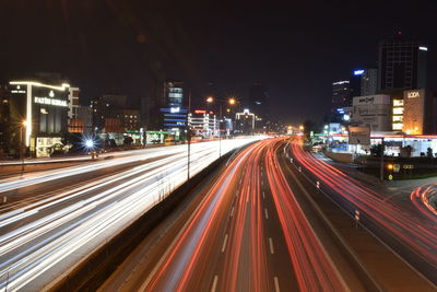 High angle view of light trails on road at night