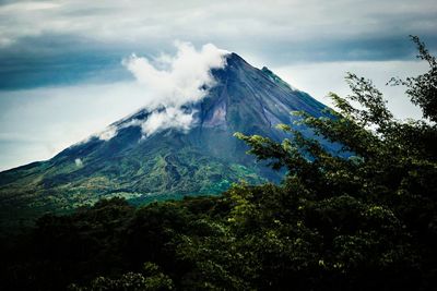 Scenic view of mountains against cloudy sky