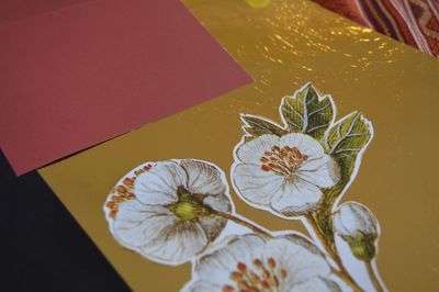 Close-up of floral pattern craft product on bed