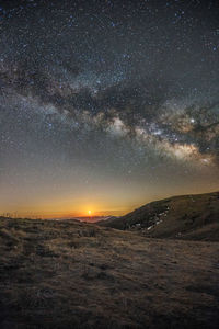 Scenic view of landscape against sky at night