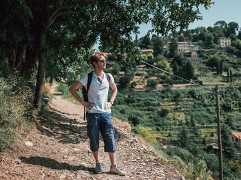 Young man wearing sunglasses standing on mountain