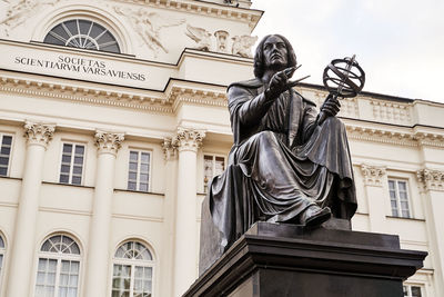 Low angle view of statue against building