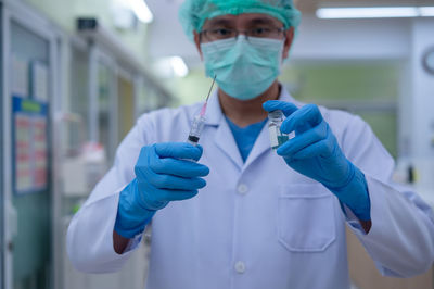 Mid section of person holding umbrella