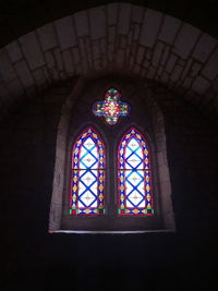 Low angle view of stained glass window in building